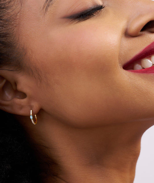 Model Wearing Marquise Blue Gemstone and Diamond Huggie Hoops