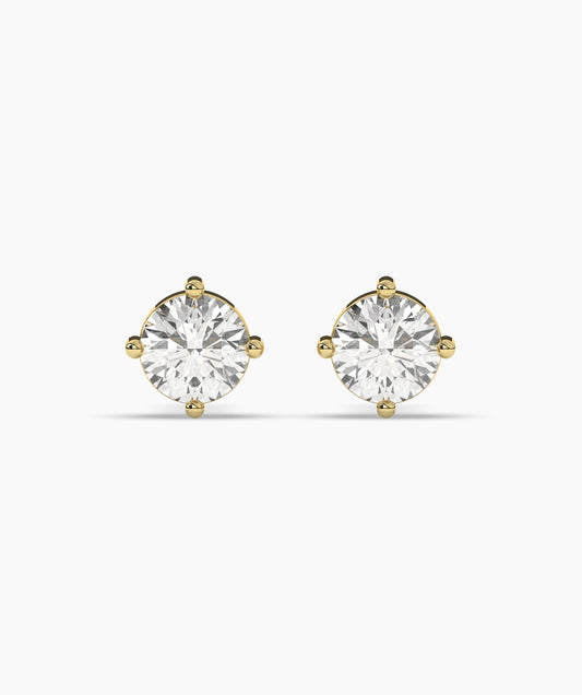 Gold stud earrings on a white background