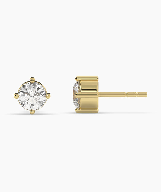 Gold stud earrings on a white background